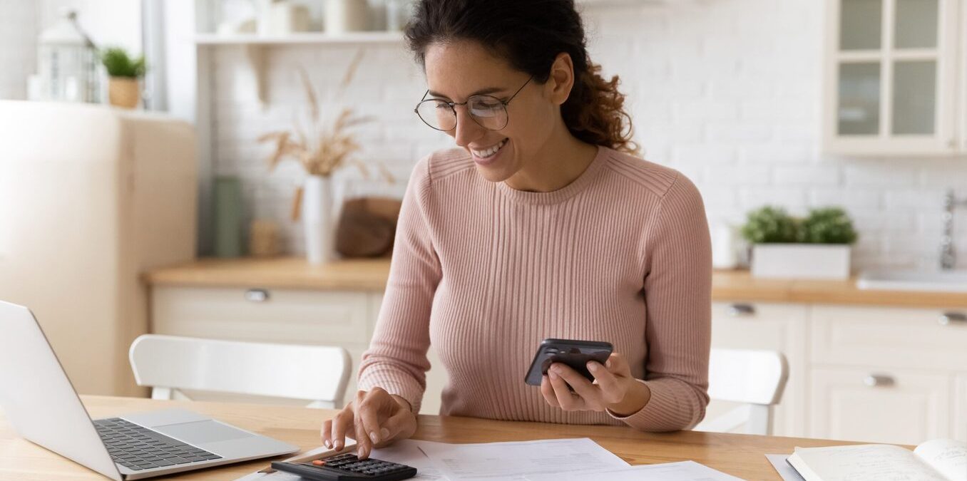 Woman doing calculations and smiling